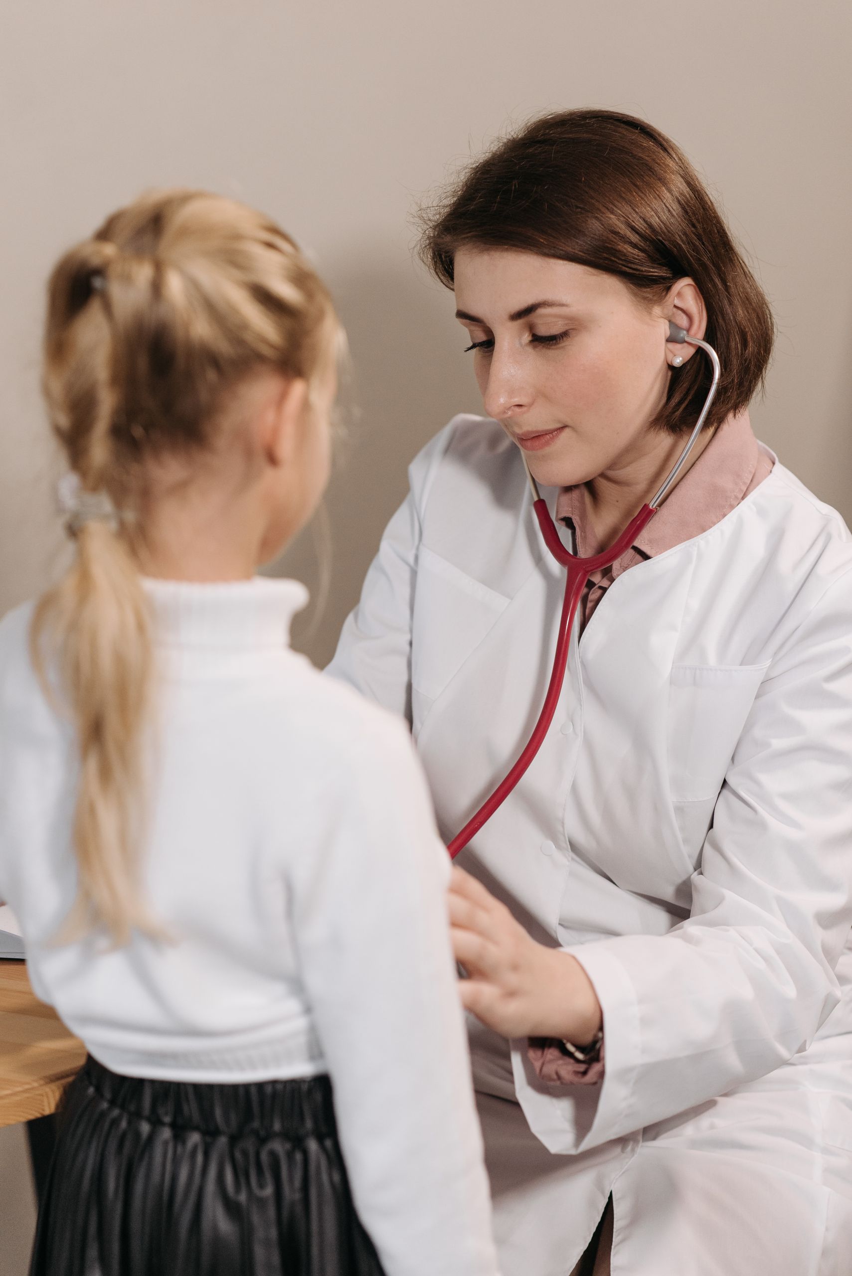 Family doctor doing children's health checkup